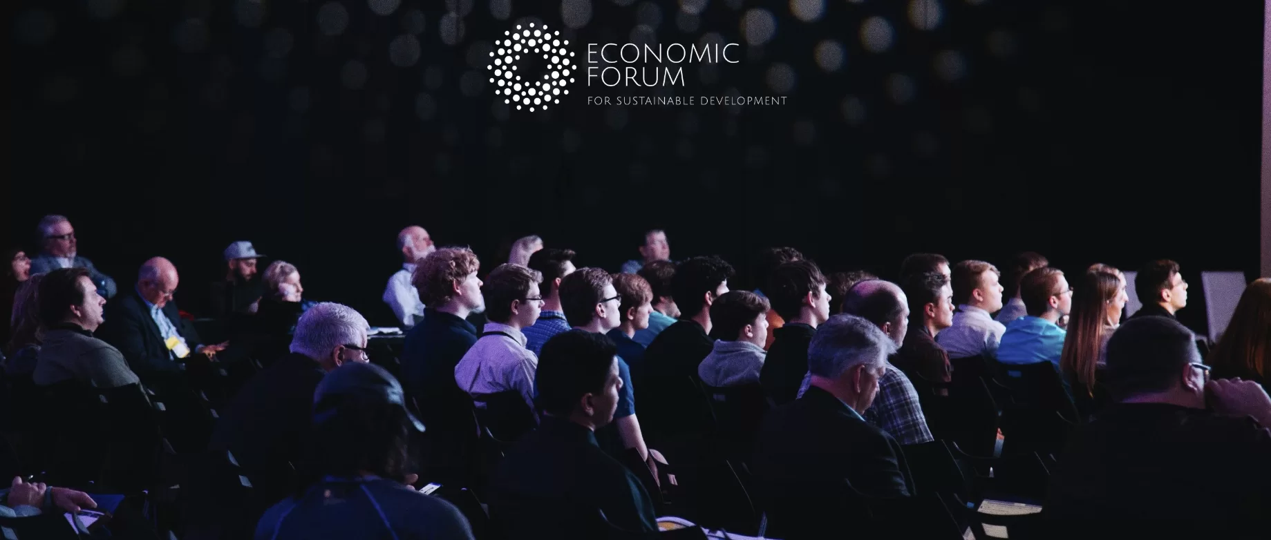 group of people sitting at a conference